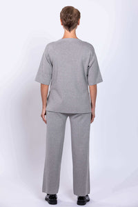 Back view of woman in grey Bailey track pant and top