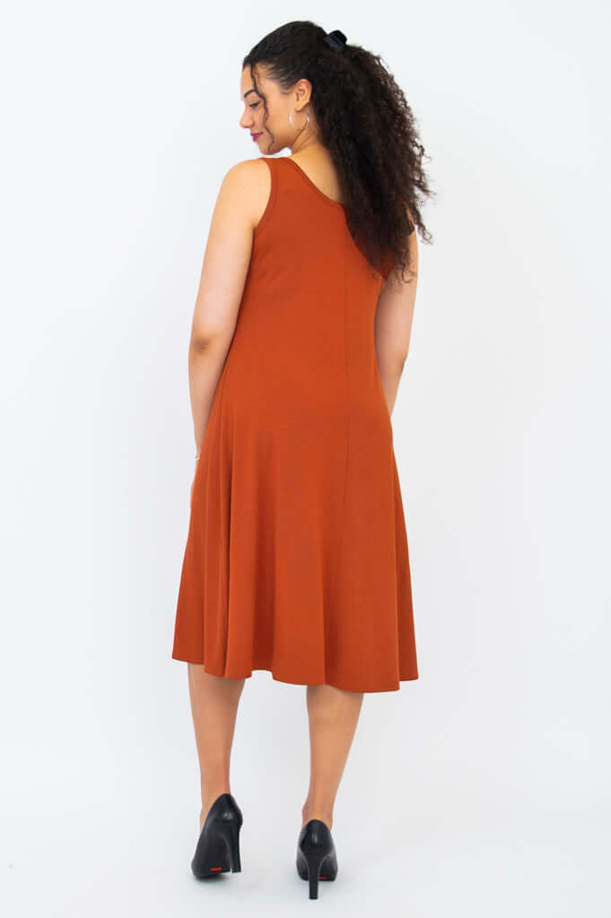 Back view of the Becca dress in burnt orange showing A-line fit and wide shoulder straps