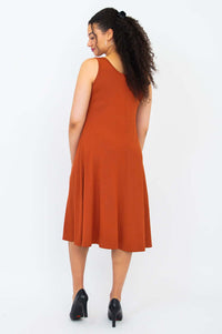 Back view of the Becca dress in burnt orange showing A-line fit and wide shoulder straps