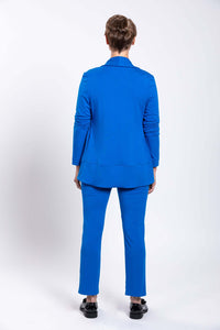 Back view of woman in blue French Terry jacket and pants with black shoes