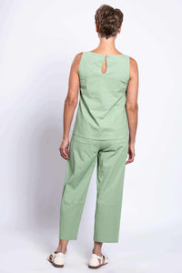 Back view of woman in sleeveless green linen top and cropped boardwalk pants showing back pocket details