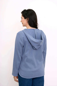 Back view of woman wearing light blue hoodie jacket