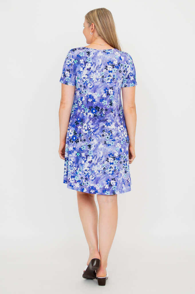 Back view of woman wearing a violet floral short sleeve dress