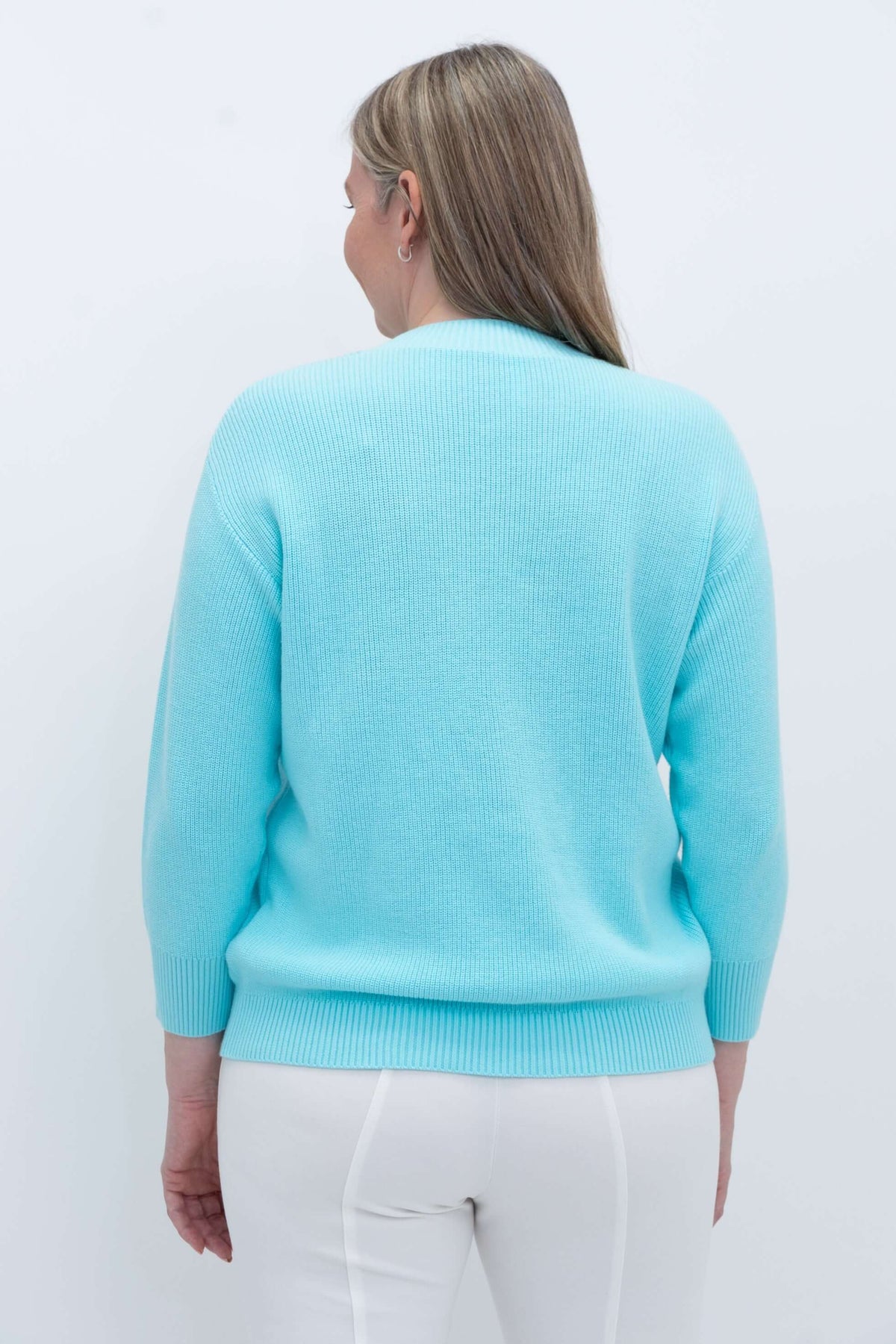 Back view of woman wearing a light blue cotton sweater