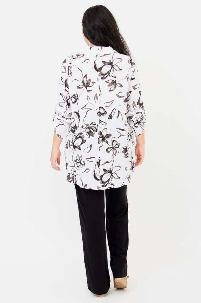 Back view of woman wearing white oversized floral bamboo linen tunic