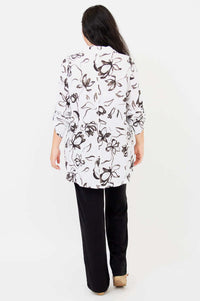 Back view of woman wearing white oversized floral bamboo linen tunic
