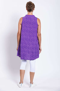 Rear view of woman wearing violet sleeveless tunic top showing a loose fit and pattern