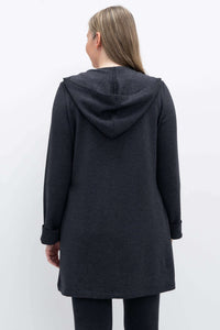 Back view of woman in dark charcoal hooded jacket, showcasing hood and length