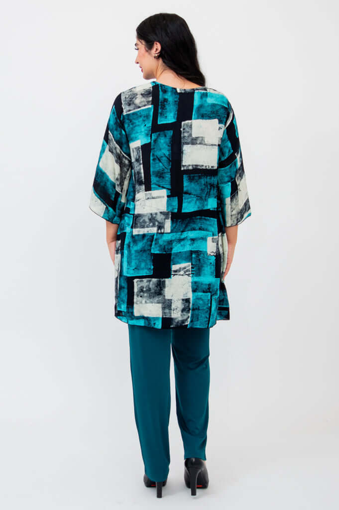 Back view of woman wearing Darla blouse showing high-low hem design