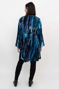 Back view of model wearing Darla blouse showcasing high-low hem and flowing fit