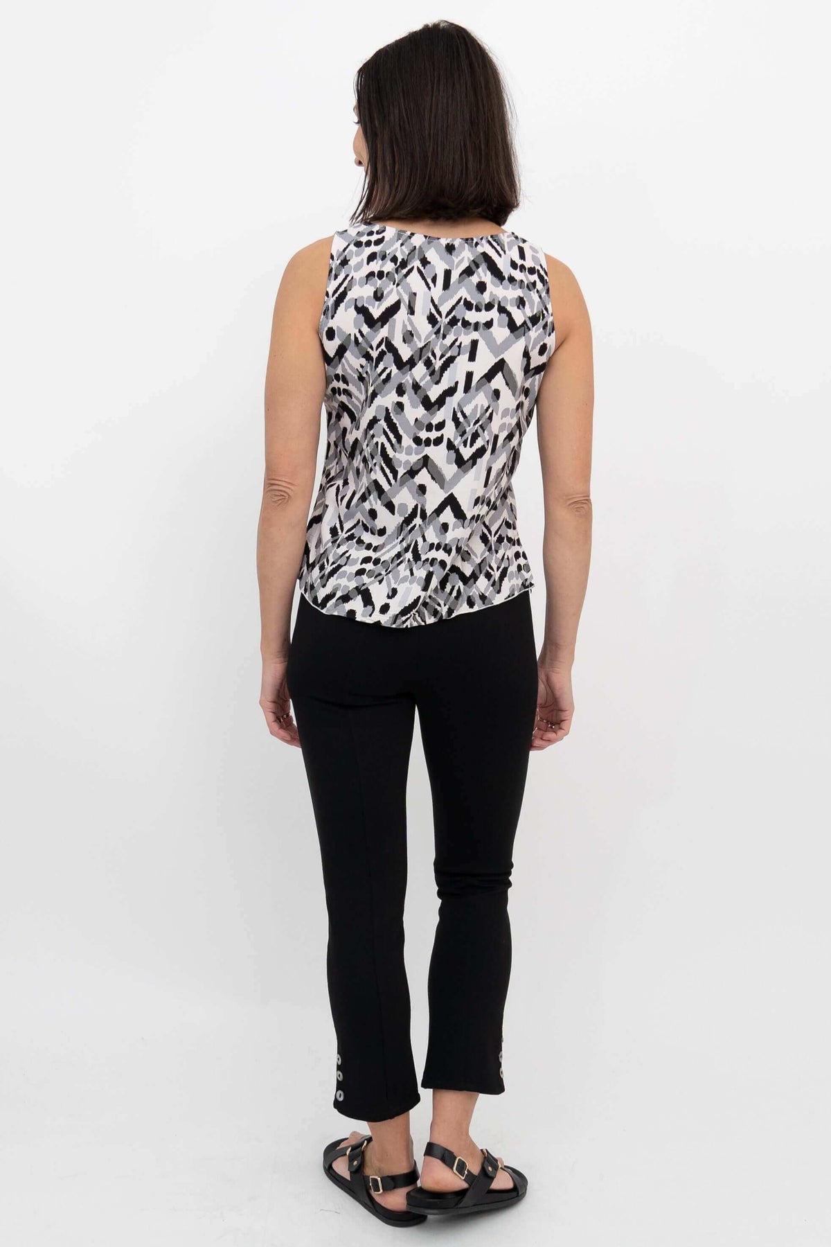 Back view of woman showing sleeveless black and white geometric print tank top