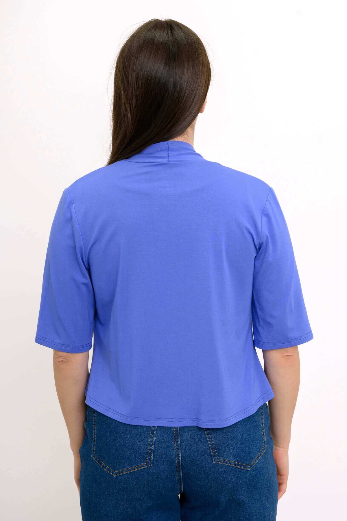 Back view of woman wearing blue cropped jacket