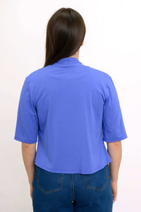 Rear view of woman displaying back details of blue cropped short sleeve bamboo jacket