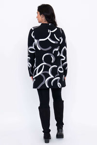 Back view of  tunic showing all-over abstract pattern in white and grey.