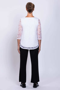 Back view of model wearing Ellen Top showing lace sleeves and rounded hem