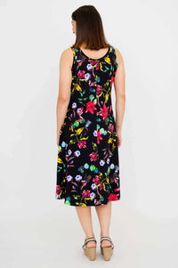 Back view of a woman in a black tank dress with vibrant floral patterns