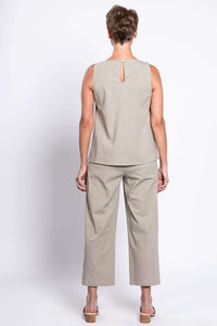 Back view of woman in beige sleeveless tank top with button closure and matching pants