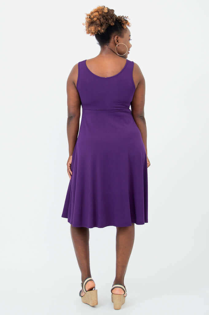 Back view of woman in a sleeveless violet fit and flare dress