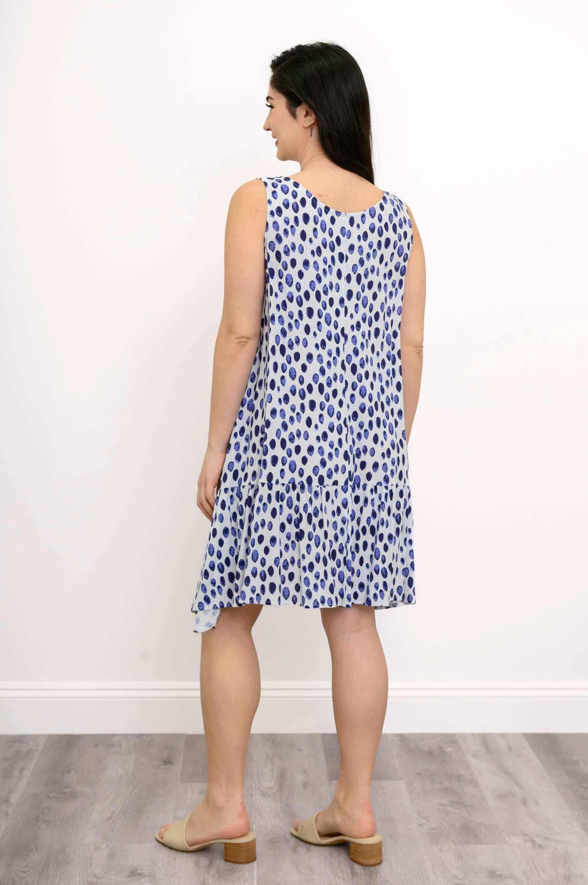 Back view of blue and white flowy sleeveless Gia Dress with ruffle detail