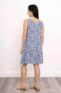 Back view of blue and white flowy sleeveless Gia Dress with ruffle detail