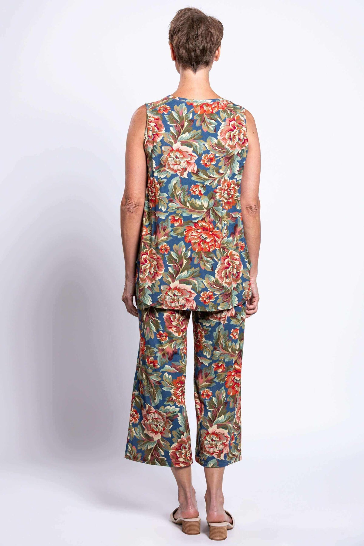 Back view of a woman wearing a sleeveless bamboo tank and pants, showcasing floral print
