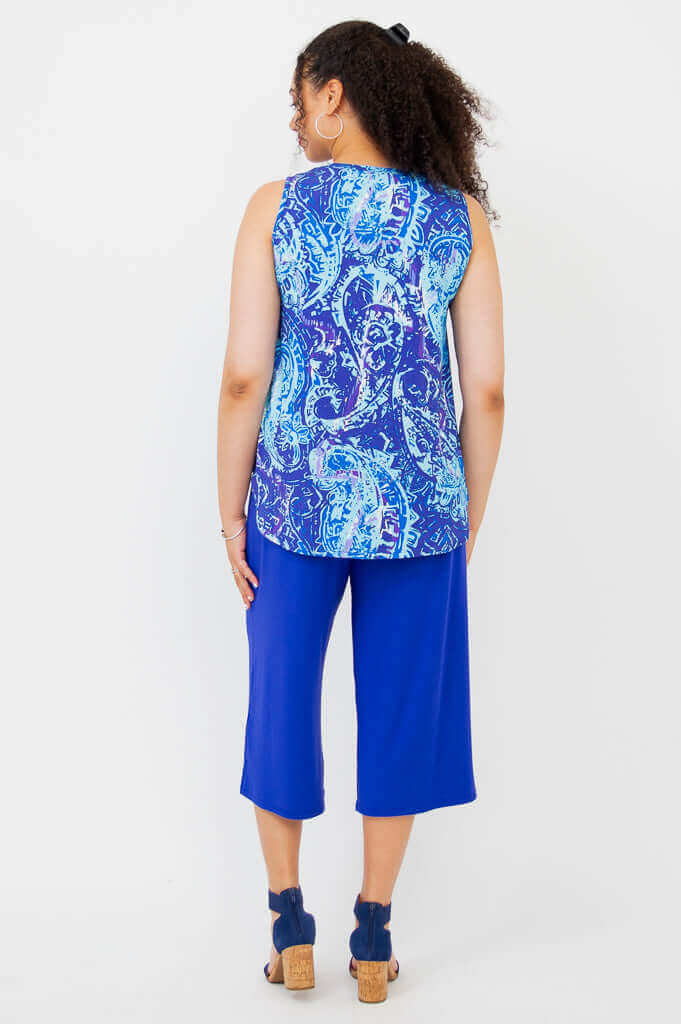 Back view of woman wearing blue batik tank top and matching blue pants