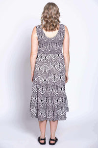 Back view highlighting the scoop neck and pattern of a sleeveless black and white midi dress