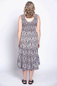 Back view of woman in sleeveless black and white patterned tiered dress