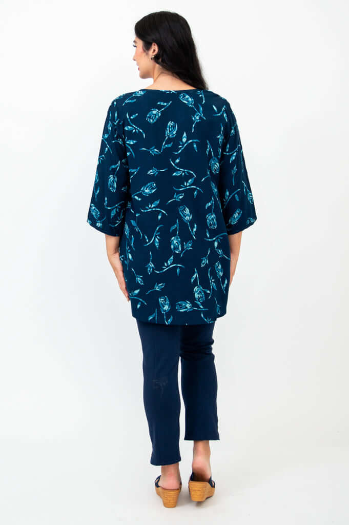 Back view of model wearing the Kary Tunic Top in Indigo Rose print