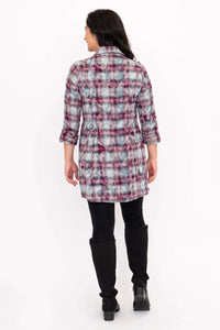 Back view of a woman in a plaid flannel tunic shirt with 3/4 sleeves