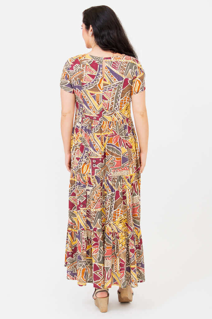 Back view of a woman in a geometric print short sleeve maxi dress