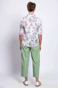 Back view of woman modelling half-sleeve botanical print top and pastel green pants