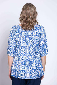 Back view of blue and white boho peasant top worn by a woman