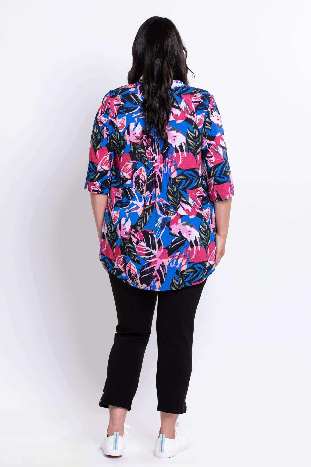 Back view of woman showing the flow of the Margate blouse with vivid leaf print