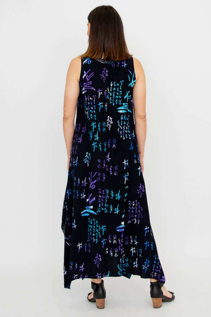 Back view of woman in a sleeveless black dress with geometric blue and purple patterns