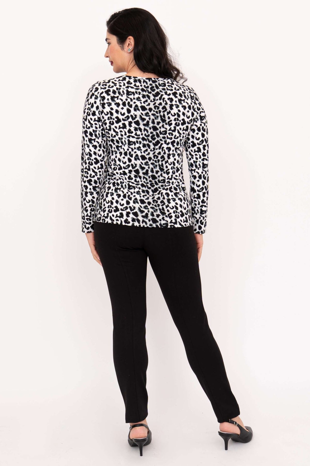 Back view of woman in leopard print long sleeve tee and black pants