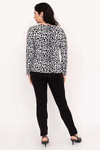 Back view of woman in leopard print long sleeve tee and black pants