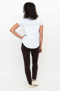 Back view of woman in Nadia slim-line brown pants with white top