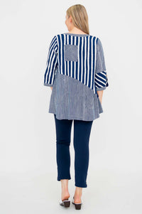 Back view of woman wearing navy and white striped blouse with block pattern and back pocket detail