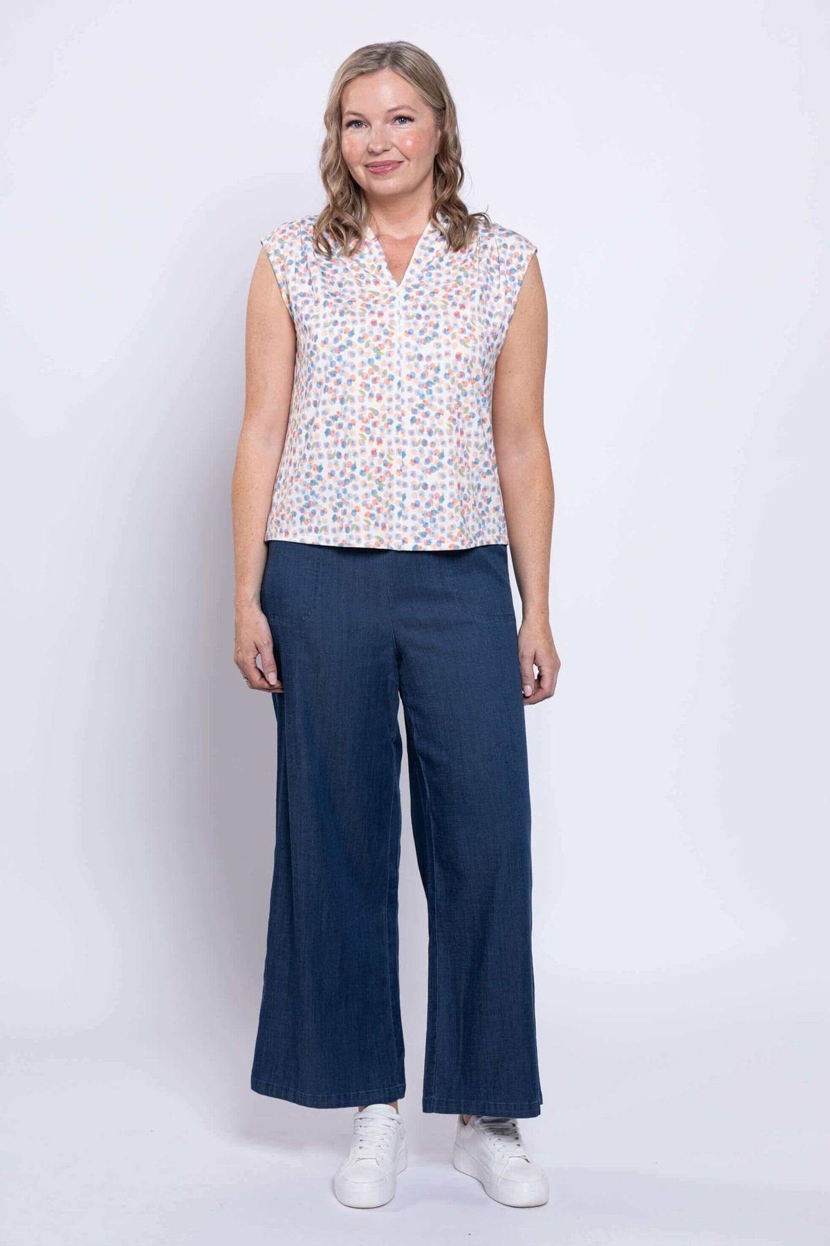 Back view of Paula Top showing colorful print and cap sleeves worn by model