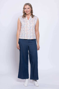 Back view of Paula Top showing colorful print and cap sleeves worn by model