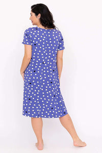 Back view of woman wearing a purple polka dot short-sleeve sleepshirt