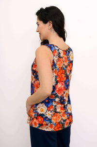 Woman showing the back of a reversible floral print tank top