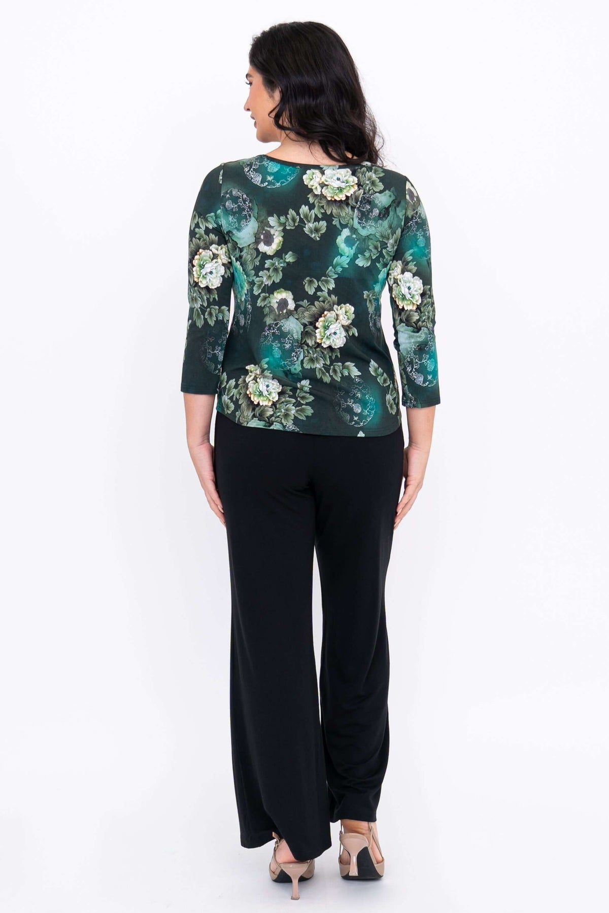 Back view of green floral sweetheart top with 3/4 sleeves, paired with black pants