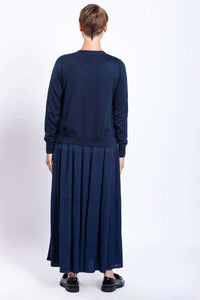 Back view of model wearing navy tiered maxi skirt and navy cardigan