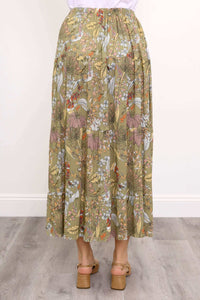 Back close-up view of woman wearing tiered ruffle skirt with elastic waistband and khaki floral pattern