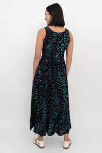 Back view showing tie waist and vibrant abstract pattern on maxi dress