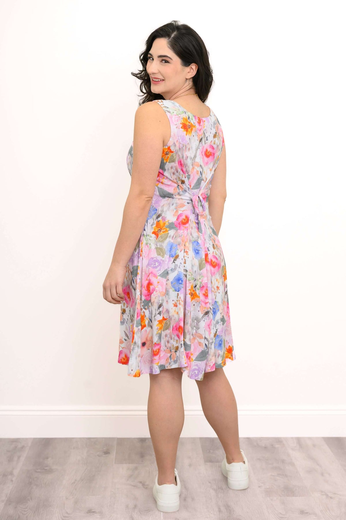 Back view of a woman in a tie-belt floral summer dress