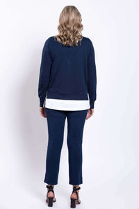 Back view of model wearing navy slim-fit pants and cardigan