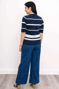 Back view of woman in navy and white striped Serena Sweater and wide-leg denim jeans